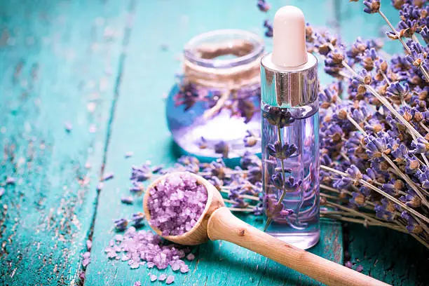 Photo of lavender flower,oil,salt, spa beauty concept. wood old background.