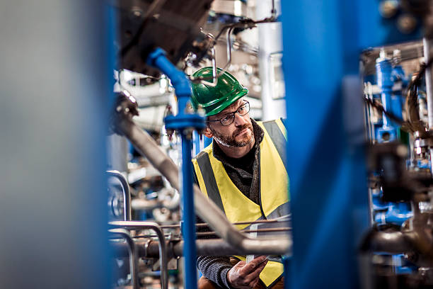 istock Serious manufacturing professional analyzing machines at factory 490717416