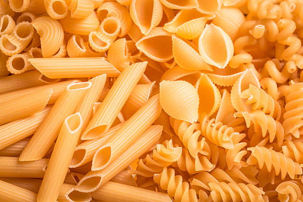istock Various mix of pasta on wooden rustic background. 490717658