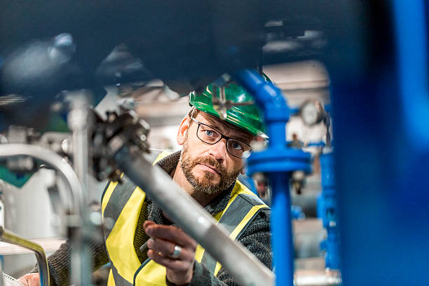 istock Manufacturing worker analysing machines at factory 490718202