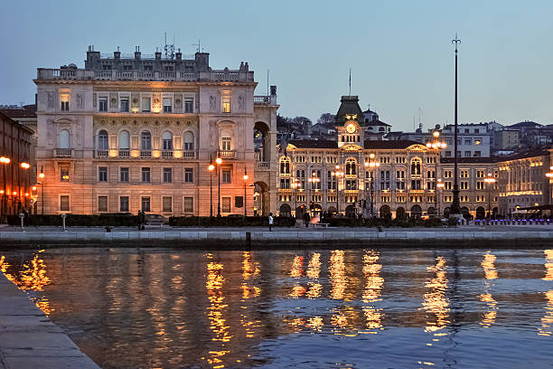 Buildings on the waterfront of Trieste after the sunset stock photo