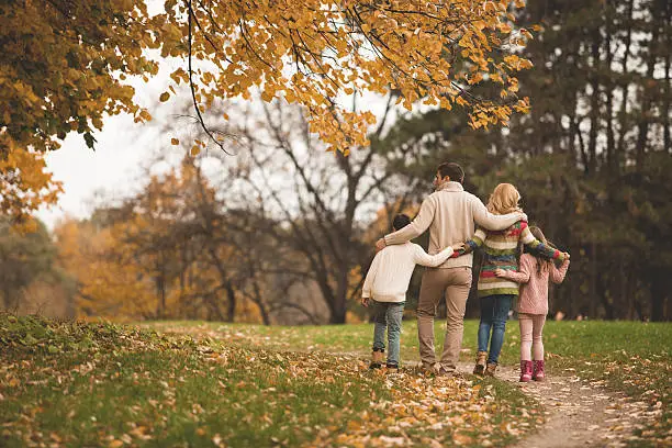 Photo of Family walking in the park