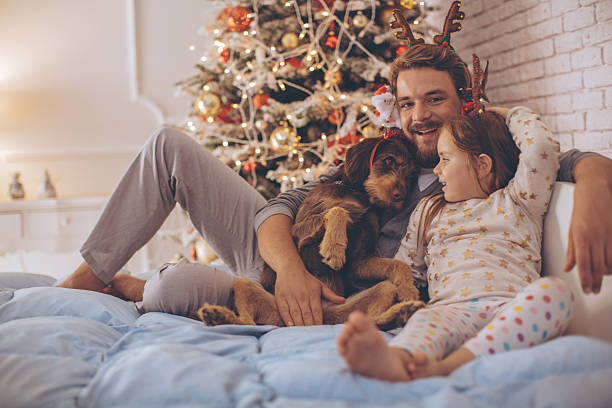 istock Father and his cute daughter in front of christmas three. 490720064