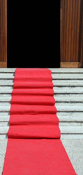 istock steps of the staircase with red carpet and door 490720680