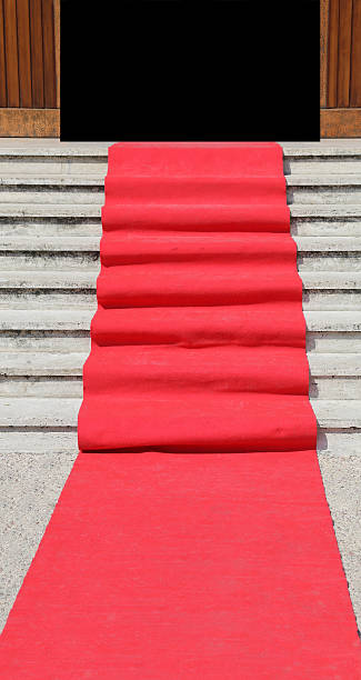 istock staircase with a luxurious red carpet toward the open door 490720714