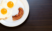 istock smiling breakfast,  fried egg and bacon in plate 490723110