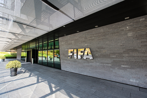 Zurich, Switzerland - 1 October, 2015: The entrance of the FIFA headquarter in Zurich. The International Federation of Association Football is the governing body of association football, futsal and beach football. FIFA is responsible for the organisation of football's major international tournaments, notably the World Cup.