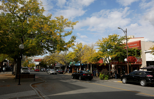 Kamloops, Canada- September 26, 2015: Victoria Street, Downtown Kamloops, British Columbia, Canada in Autumn. Pedestrians and morning traffic on the tree-lined streets in the retail district. Kamloops is a transportation hub with an extensive rail network.