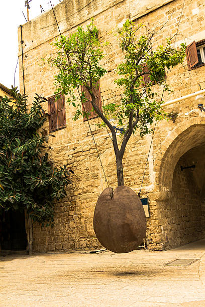 istock Orange tree in stone vessel levitating in Jaffa . Israel 490724574