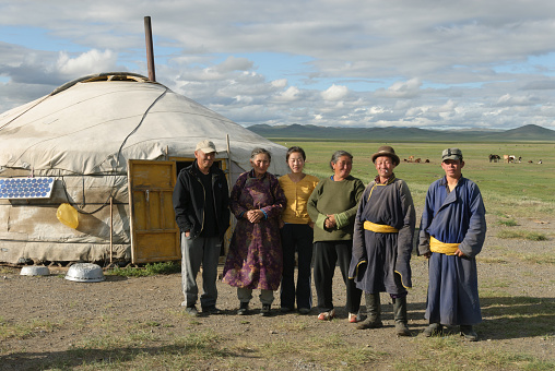 Arbajxeer, Mongolia - August 14, 2006: The outskirts of Arbajxeer town. Nomad family is standing in front of Gel house (Yurt).