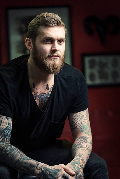 istock Confident tattoo artist sitting at studio 490729170