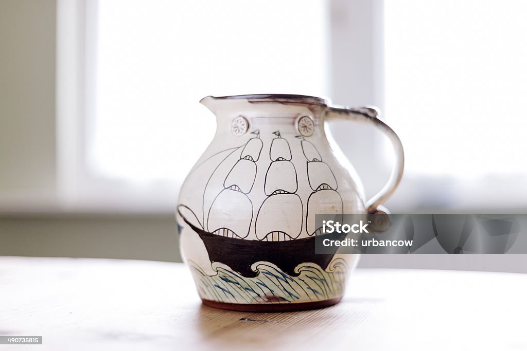 Hand painted jug Hand painted ceramic cups, decorated with a sailing ship, on a studio shelf. Rosemary Jacks Pottery, Devon.  Art And Craft Stock Photo