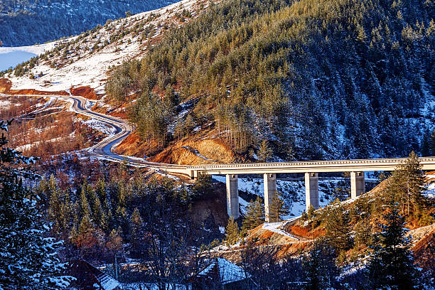 istock Mountain bridge in winter with snow and blue sky 490736069