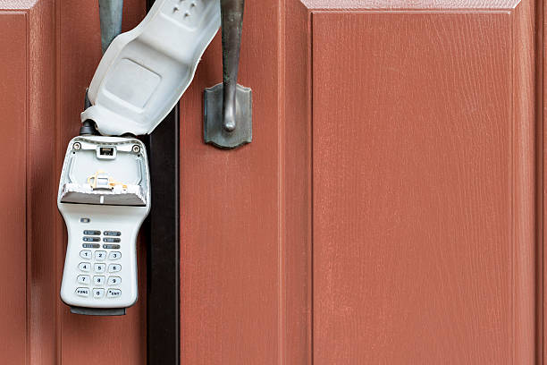 Real Estate Lock Box Lock box on home. Used by realtors to enter homes for sale. key package stock pictures, royalty-free photos & images