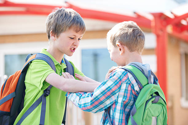 Two Boys Fighting In School Playground Intimidating behaviour schoolyard fight stock pictures, royalty-free photos & images