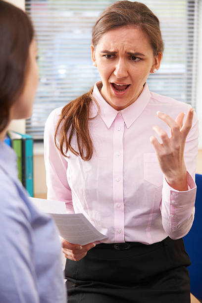 istock Aggressive Businesswoman Shouting At Female Intern 490739325