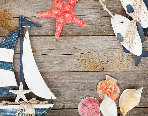 istock Toy sailboat and fish with seashells and starfish 490752300