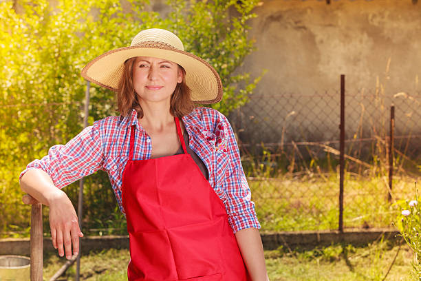 istock woman standing with shovel in garden 490754754