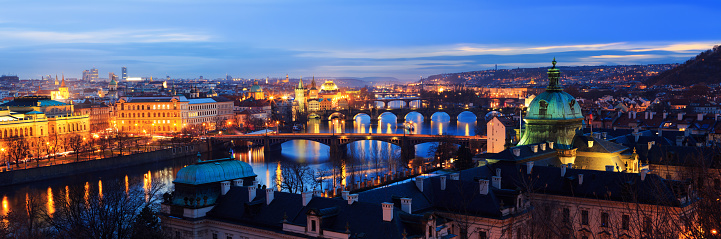 Illuminated panorama of Prague bridges (Czech Republic).