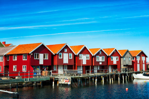 istock Boathouses in a row on a wooden jetty 490755050