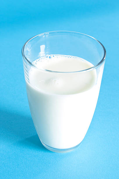 istock Glass of fresh milk on a blue background 490756218