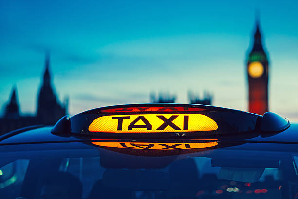 Taxi sign in London Close up of a London taxi sign, Big Ben in the background black taxi stock pictures, royalty-free photos & images