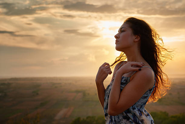 istock girl portrait at sunset on plain background 490760006