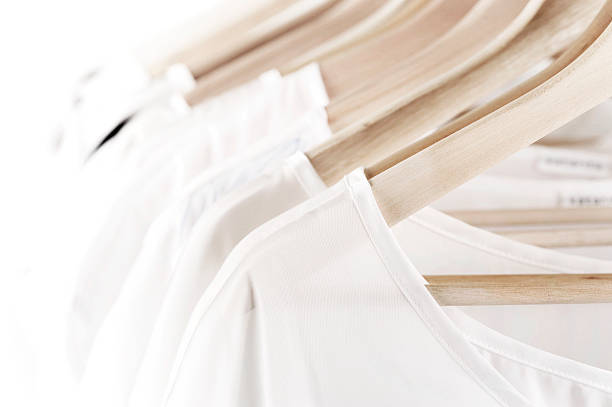 White clothes on hangers stock photo