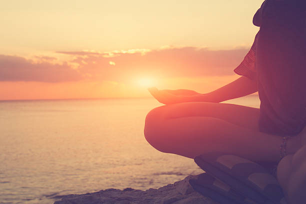 istock Young woman practicing yoga on the beach. 490761472