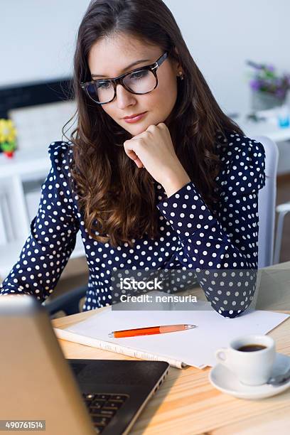 Beautiful Young Woman Working With Laptop In Her Office Stock Photo - Download Image Now