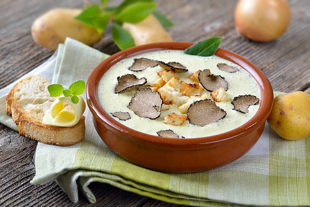 Potato soup with truffles Cream of potato soup with delicious sliced black autumn truffles, served with toasted ciabatta bread with a butter roll tartuffo stock pictures, royalty-free photos & images