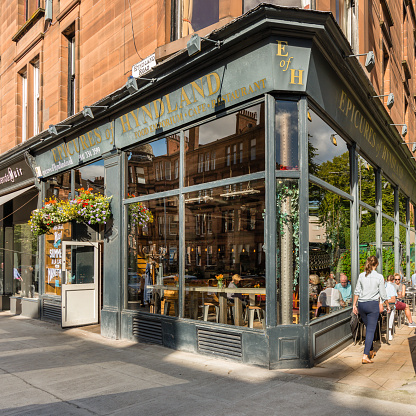 Glasgow, Scotland - September 03, 2015: Street cafe, retail units and tenement flats in Hyndland, Glasgow.