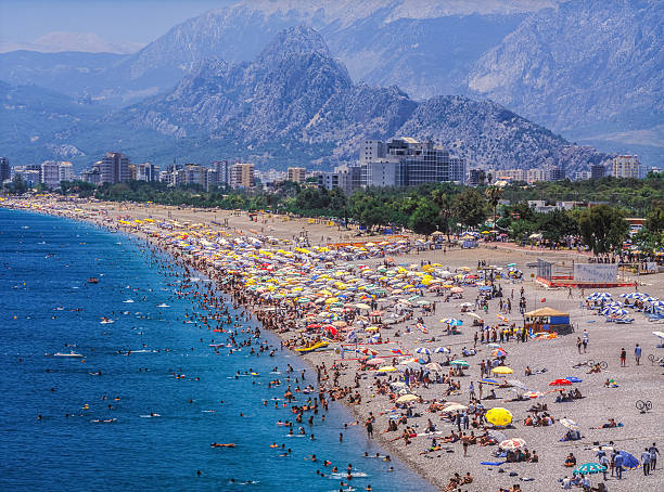 Konyaalti Beach Antalya,Turkey-June 20,2005:Most popular beach with cafe and restaurants, at the Mediterranean Sea of Turkey,named "Konyaalti Beach", in Summer.Almost in all seasons peoples run this seaside resort. antalya province photos stock pictures, royalty-free photos & images