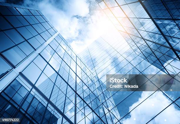 View Of A Contemporary Glass Skyscraper Reflecting The Blue Sky Stock Photo - Download Image Now