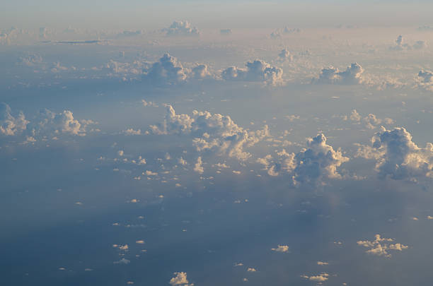 Sun rays across scattered cloud, viewed from above stock photo