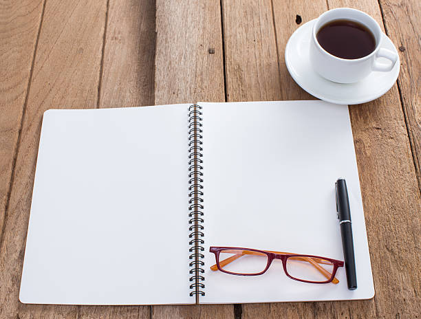 istock Blank notebook with coffee cup on old wooden background 490775999