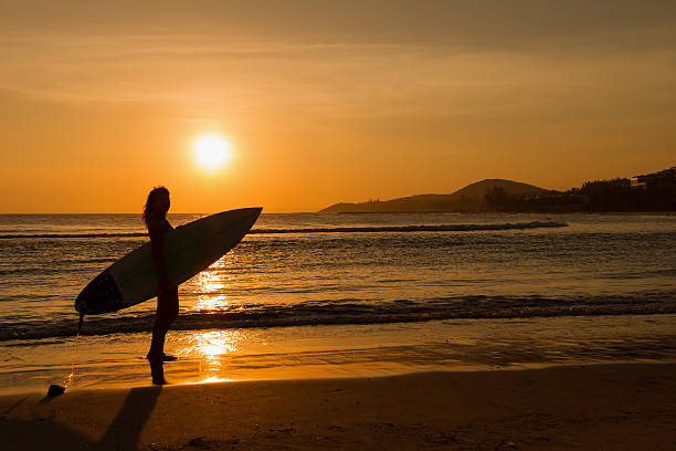 istock surfer girl in bikini on a beach at sunset 490776271