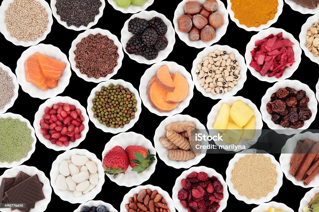 Health Food Health and superfood selection in porcelain crinkle bowls over black background. High in vitamins and antioxidants. Bean Stock Photo