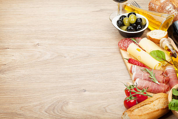 istock Red wine with cheese, prosciutto, bread, vegetables and spices 490776755