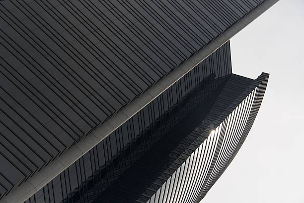 Curved sunlit facade of Hong Kong skyscraper