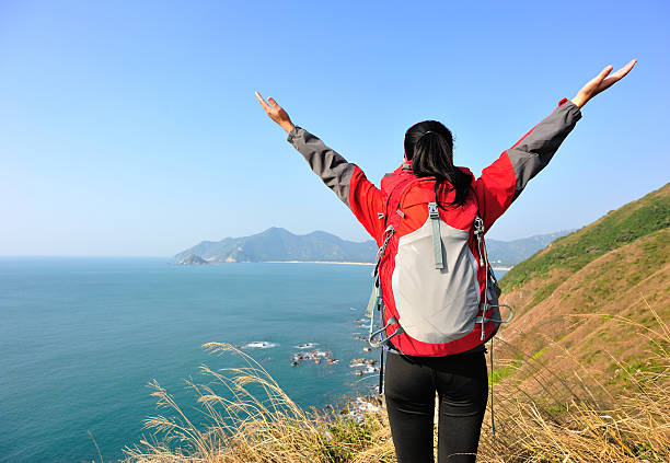 istock cheering hiking woman happy seaside 490777441