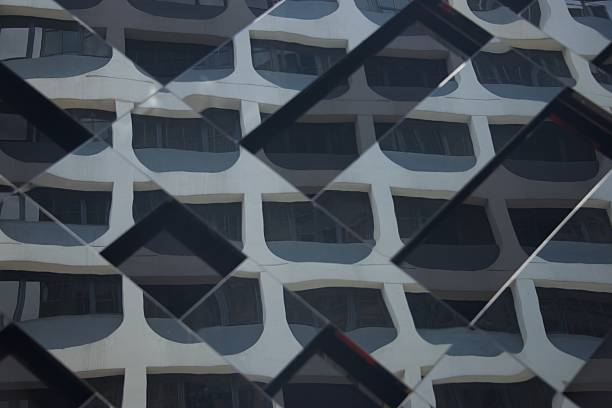istock Reflections of skyscraper in mirrored glass building 490777477