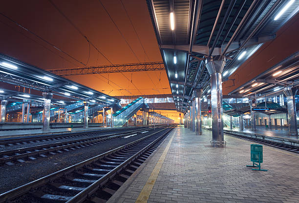 istock Railway station at night. Train platform in fog. Railroad 490777948