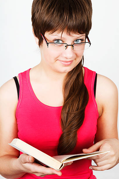 Young attractive girl holding an open book stock photo