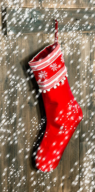 istock Christmas stocking. Red sock with snowflakes  and falling snow 490778486