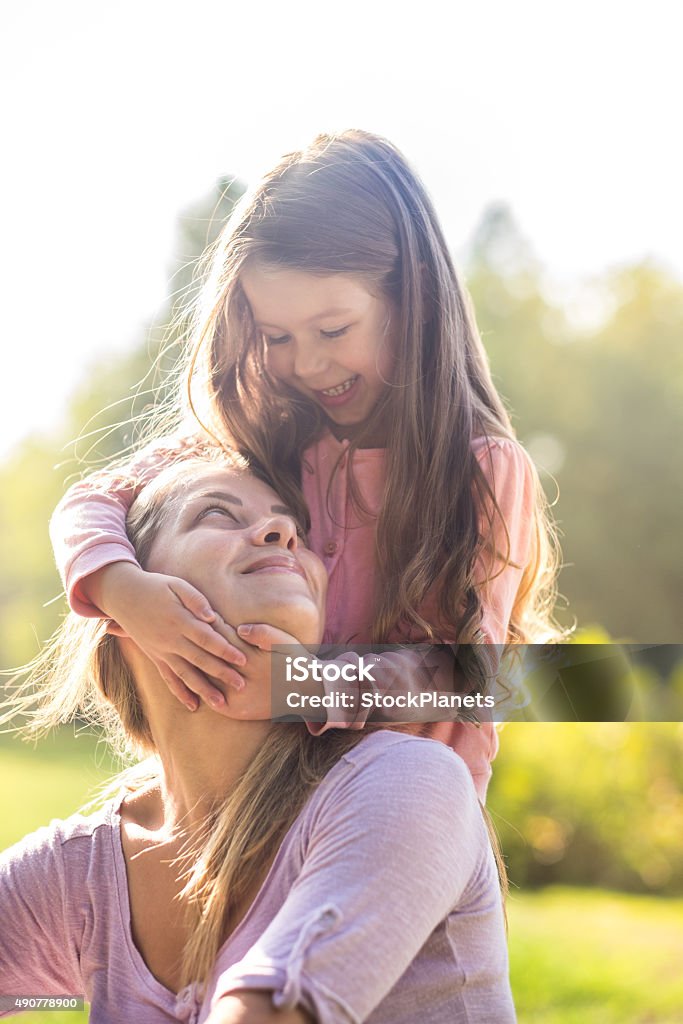 happy little girl with mom in park mom and daughter are happy togeder in park Child Stock Photo