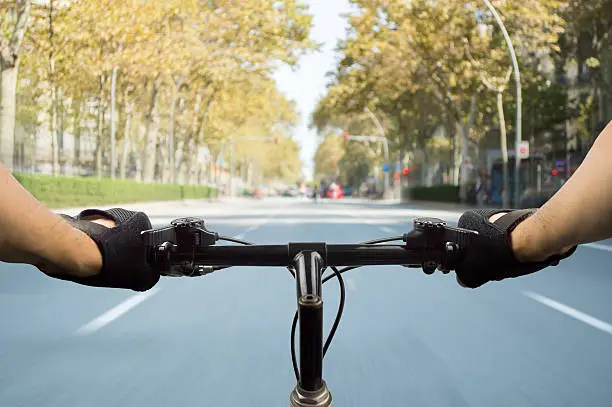 person riding a bicycle along a road in Barcelona Spain