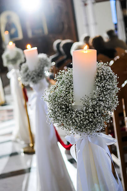 istock White candles and carnations flower wedding decoration in a chur 490780654