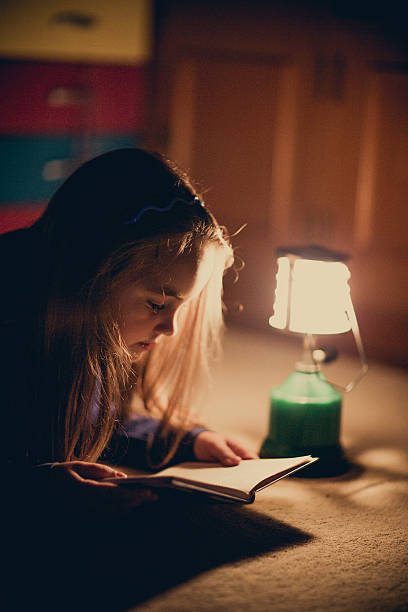 istock Girl reading book in lighting lamp 490780660