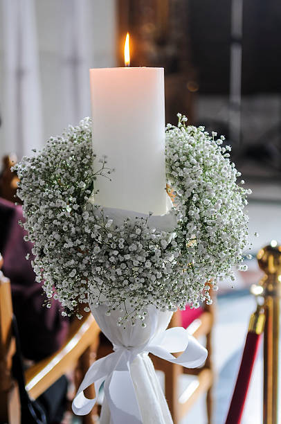 istock White candles and carnations flower wedding decoration in a chur 490780678